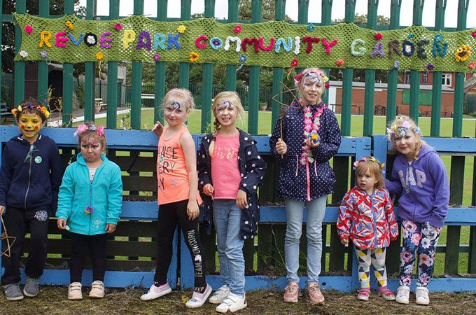 Children enjoying face painting at Revoe community garden